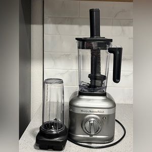 KitchenAid blender with single on-the-go cup and accessories.